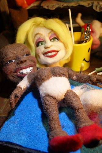 needle felting whoopi doll with dolly looking on